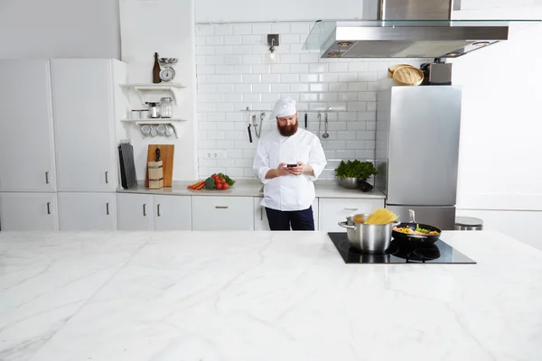 Male chef cook standing on kitchen