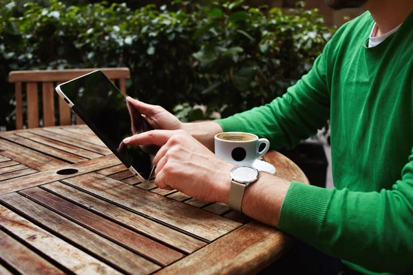 Freelancer sitting on the terrace with cup of coffee