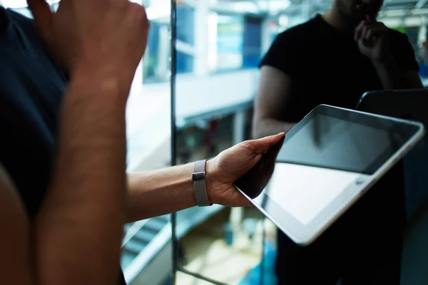 Male person using digital tablet