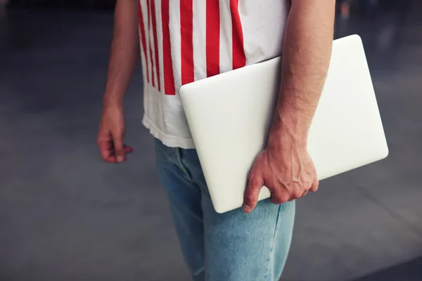 Student holding laptop close up