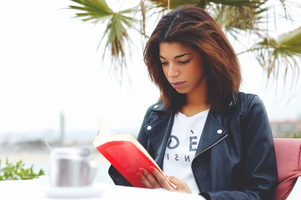 Afro american woman enjoying a interesting book