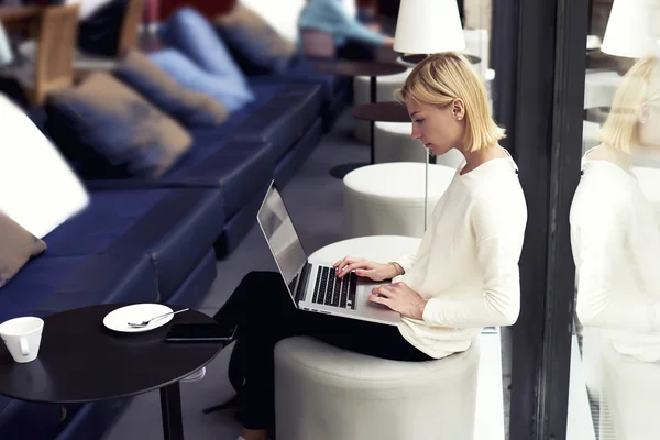 Female freelancer working on laptop computer