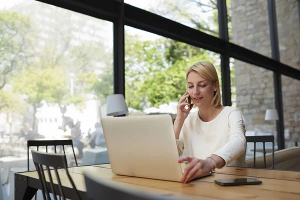 Confident female speaking on mobile phone