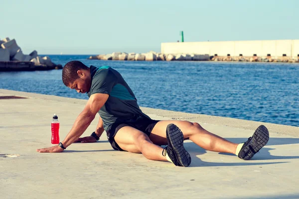 Male runner doing stretching exercise