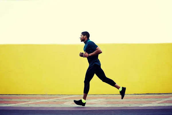 Full length portrait of strong male jogger