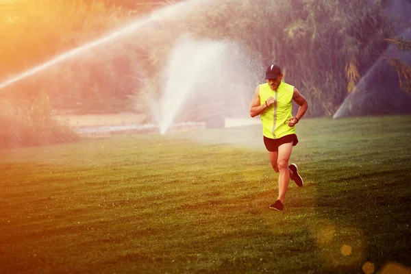 Man running cross watering park