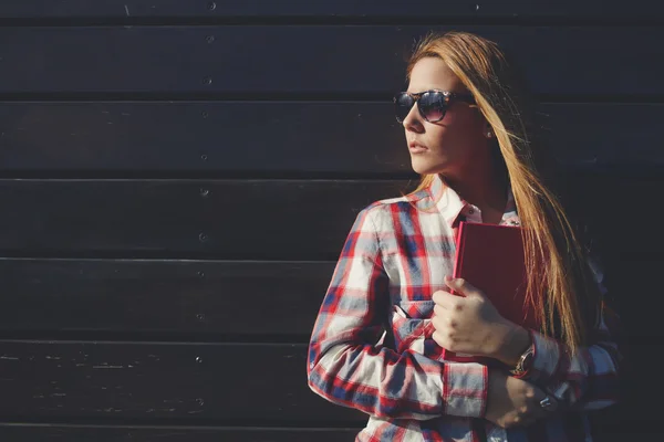 Stylish university student with book in hands