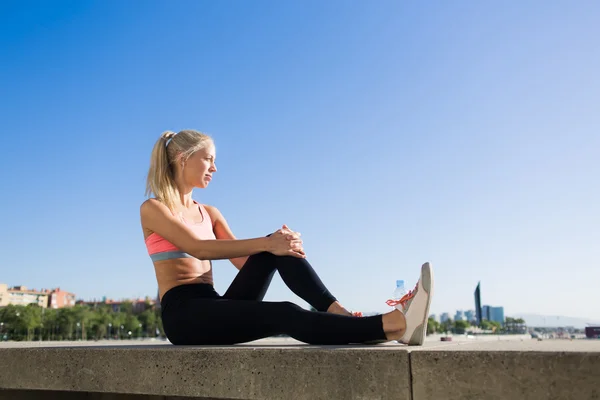 Woman enjoys resting after workout outdoors