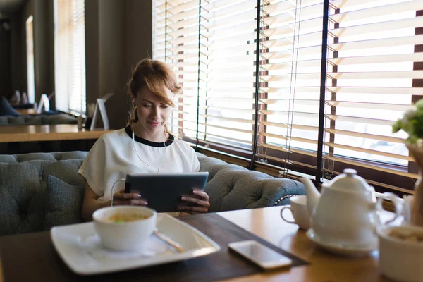 Woman browsing internet pages on her tablet