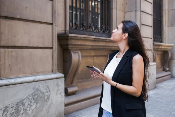 Woman with digital tablet in urban setting
