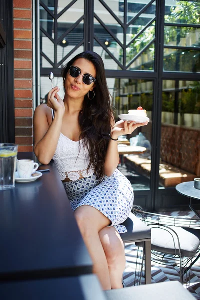 Elegant young woman in cozy cafe