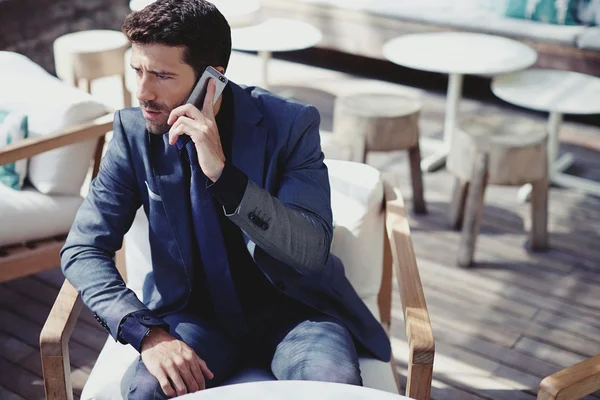 Handsome businessman talking on smart phone