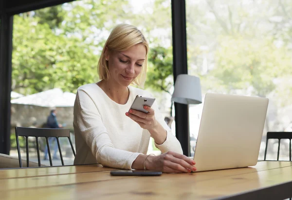 Freelancer reading text message on smartphone