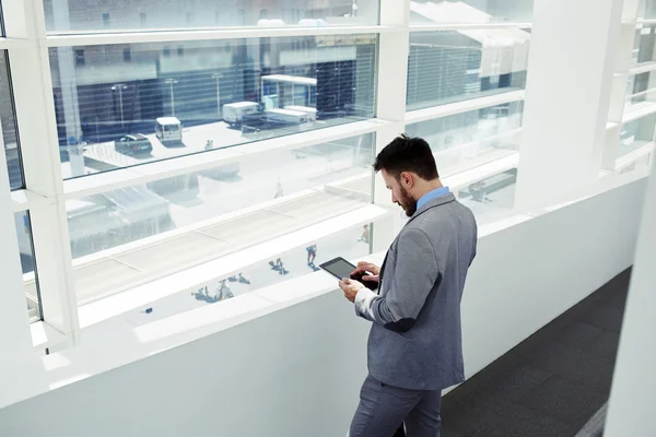 Young businessman working on touch pad