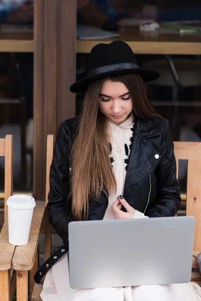 Charming woman working on net-book in cafe