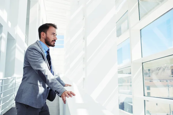 Intelligent man looking in office window