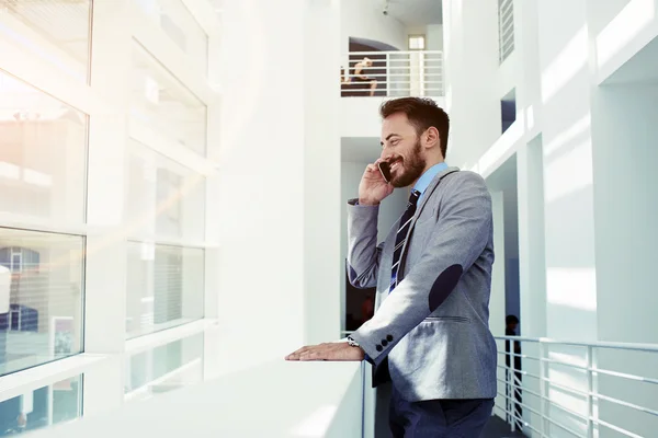 Businessman talking on mobile phone in office