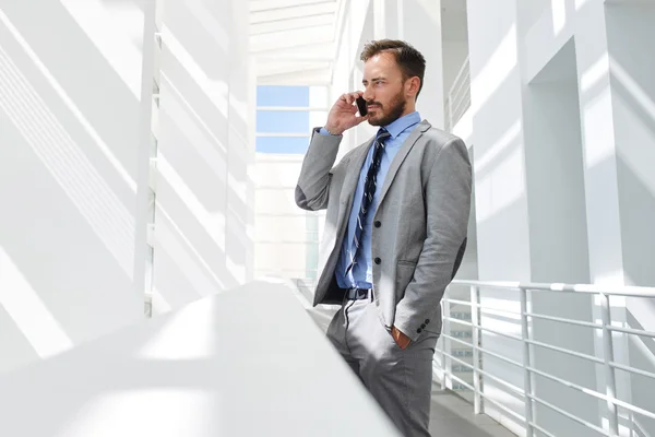 Businessman talking on mobile phone in office