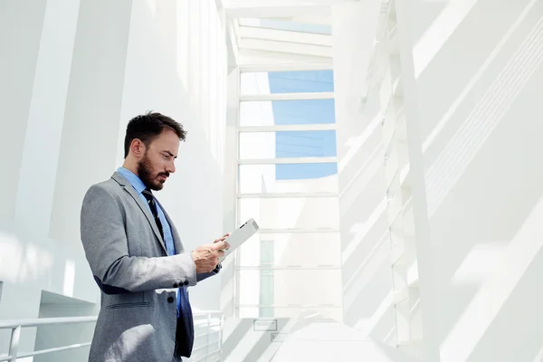 Businessman working on touch pad in office