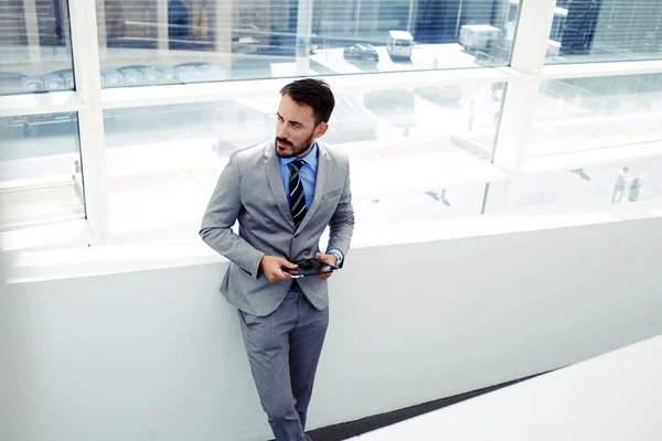 Businessman working on touch pad in office