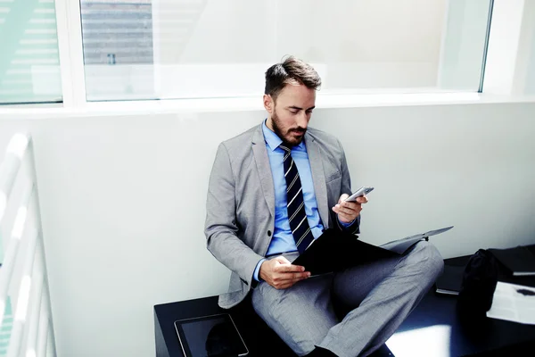 Businessman using cell telephone