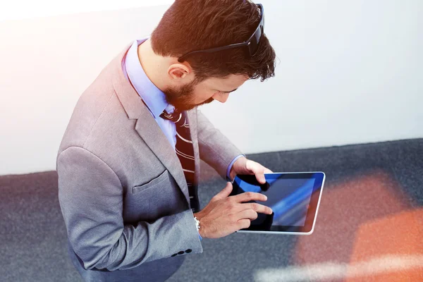 Businessman working on touch pad in office