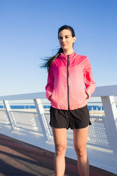 Sportswoman relaxing on a bridge outside