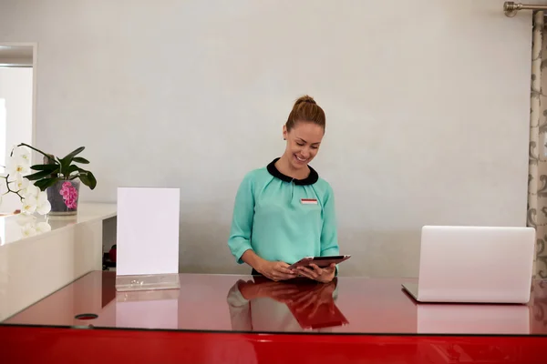 Woman working on touch pad in store