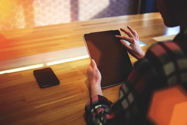 Young woman working on touch pad