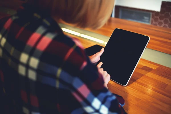 Young woman working on touch pad