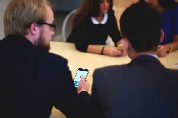 Business partners using smart phone