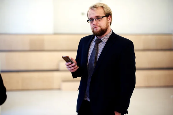 Confident businessman using mobile phone