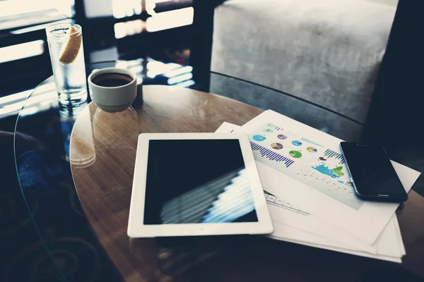 Digital tablet and mobile phone on table