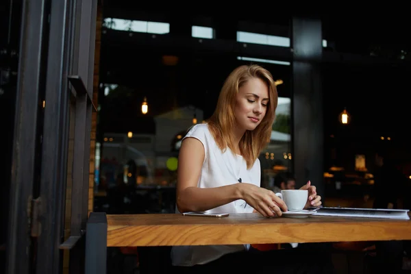 Attractive woman enjoying cup of coffee