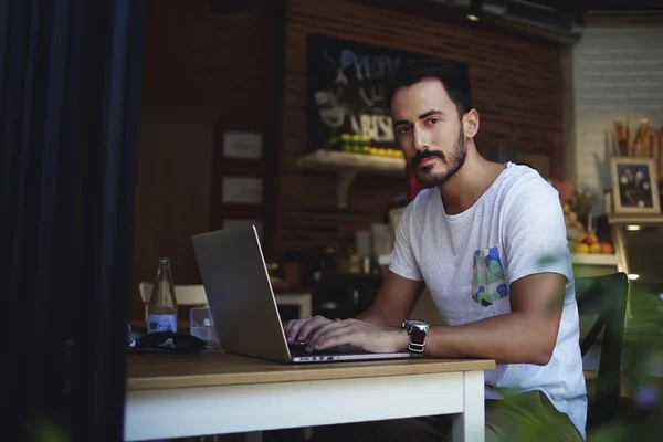 Man freelancer working on laptop computer