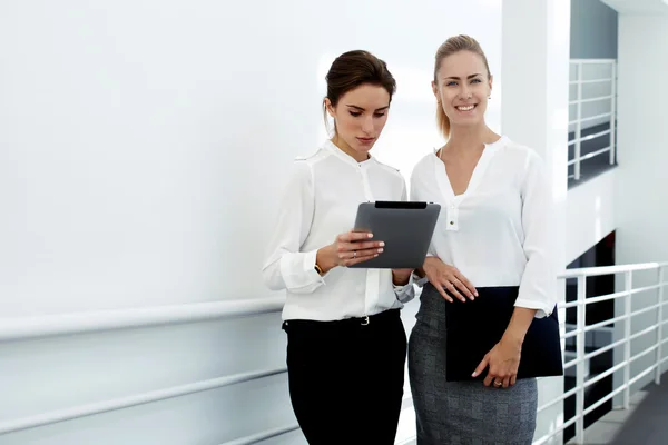 Woman financiers in office hallway