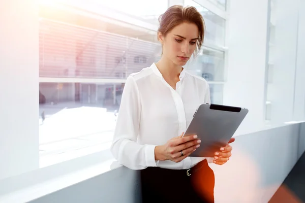 Elegant businesswoman working on touch pad