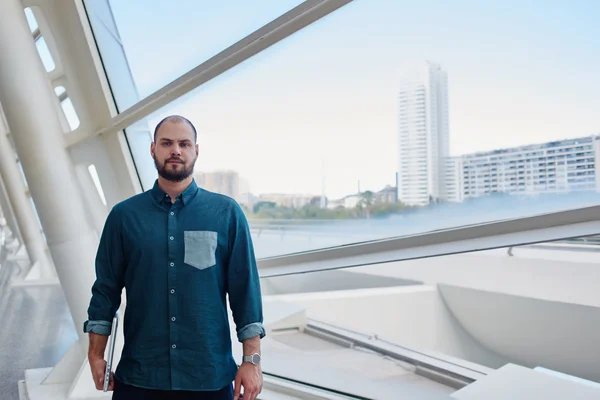 Male freelancer posing in modern office