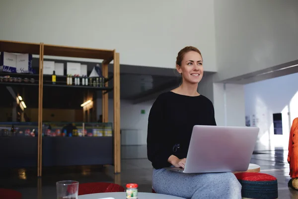 Businesswoman sitting with open laptop