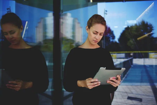 Businesswoman holding touch pad