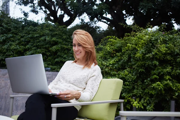 Woman watching funny video on laptop