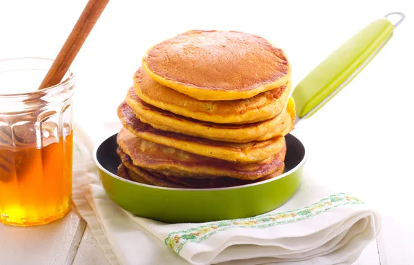Fluffy pumpkin pancakes with honey