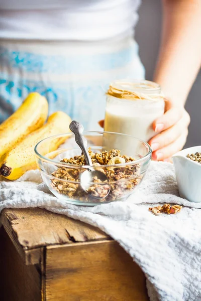 Jar of hemp seed milk, hold in your hand, a healthy breakfast