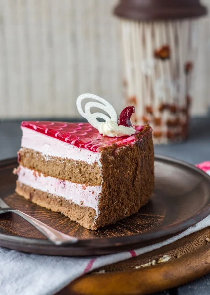 Cake with chocolate sponge cake, berry mousse and cherry jelly