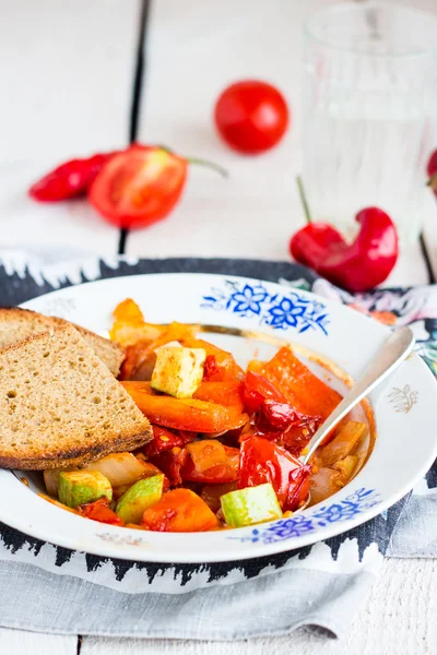 Steamed vegetables on the plate with bread, vegan