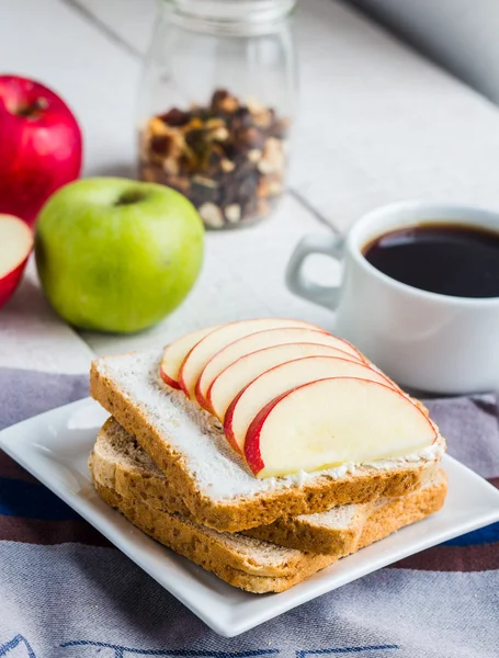 Toast with curd cheese, apple, honey and dried fruits, coffee