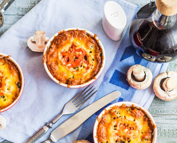 Baked mushroom julienne with tomato and cheese in red pots