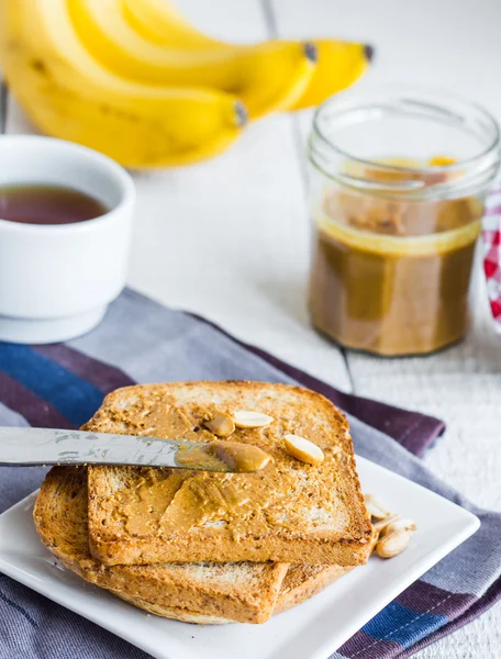 Crispy toast with peanut butter, bananas, coffee, breakfast