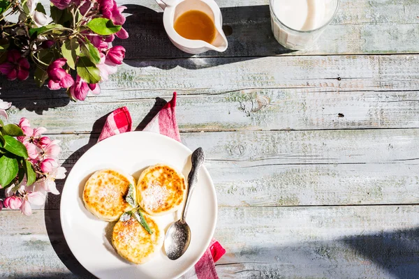 Cottage cheese pancakes with mint and powdered sugar, flowers,to