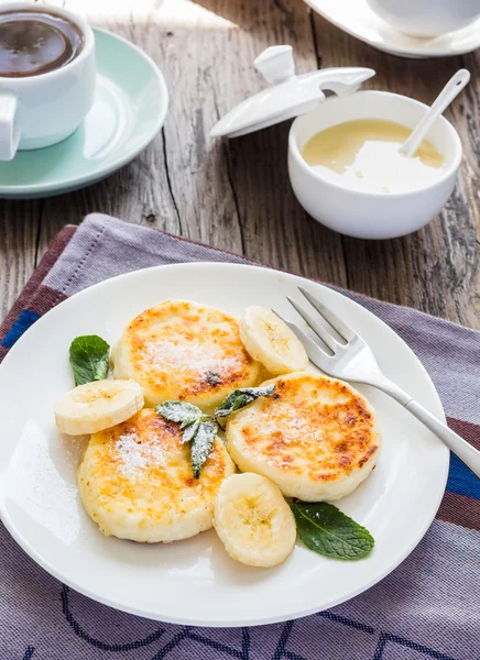 Pancakes from cottage cheese  with  banana,  condensed milk, and